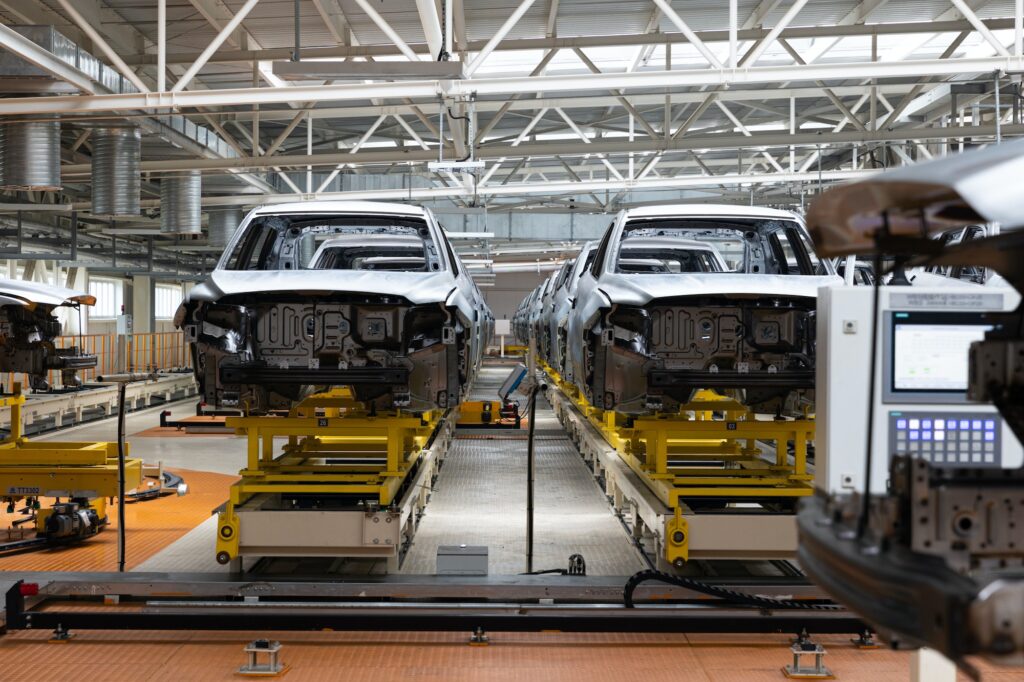 Photo of automobile production line. Modern car assembly plant. Auto industry. Interior of a high